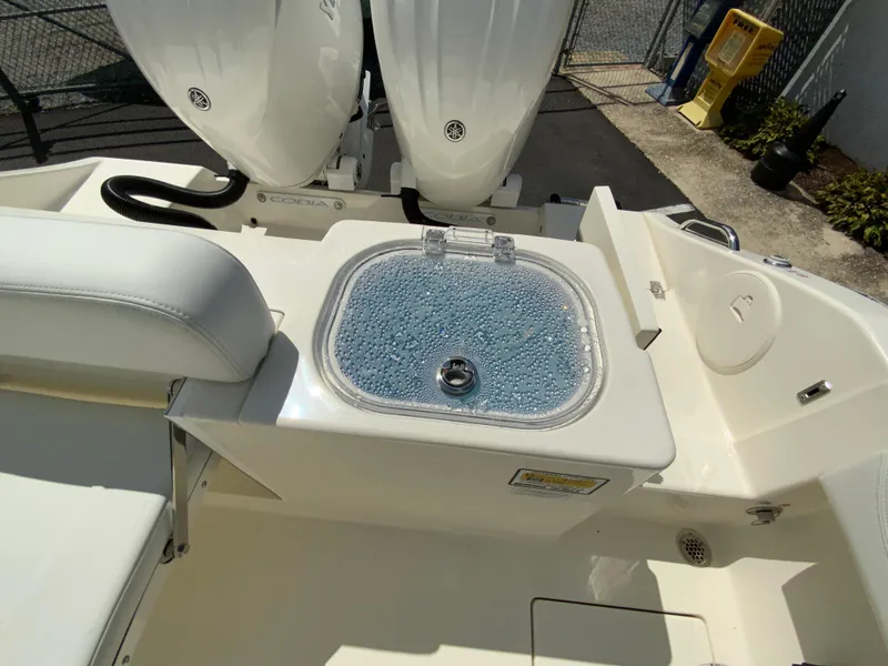 Slide: The Image of 2025 Cobia 240 Center Console boat with livewell and dual engines. - 15