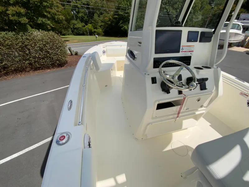 Slide: The Image of 2025 Cobia 240 Center Console boat interior with steering wheel and dashboard. - 17