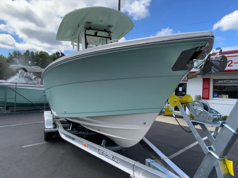 Slide: The Image of 2025 Cobia 240 Center Console boat on trailer, parked outdoors. - 2