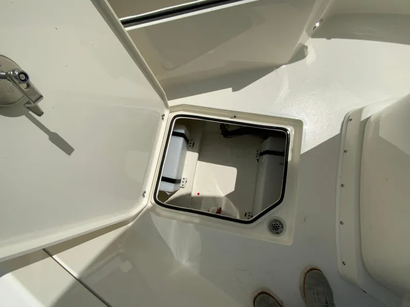 Slide: The Image of 2025 Cobia 240 Center Console boat storage compartment, open hatch view. - 20