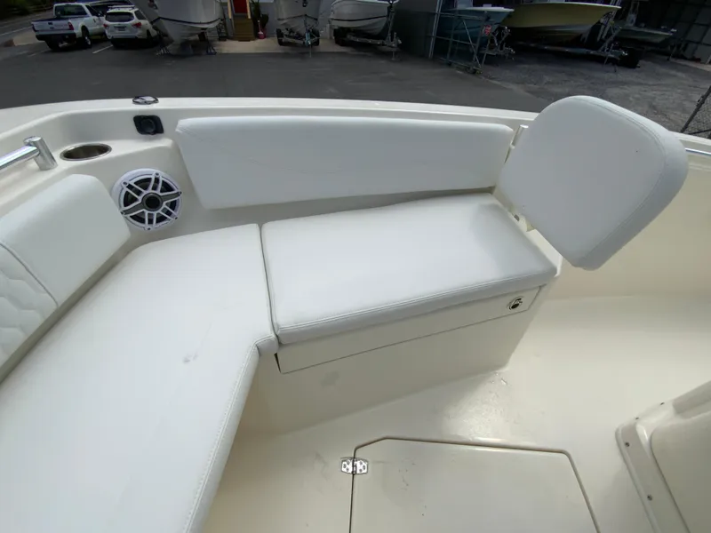 Slide: The Image of 2025 Cobia 240 Center Console boat interior with white seating and speaker. - 22