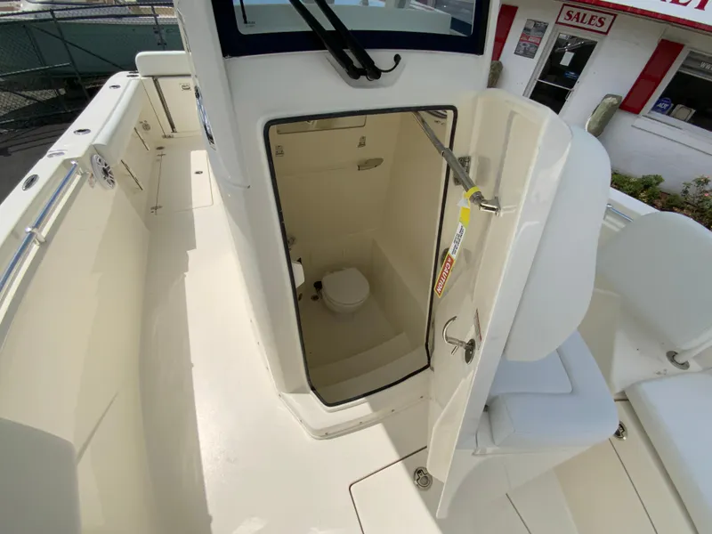 Slide: The Image of 2025 Cobia 240 Center Console boat with open cabin door showing interior. - 27
