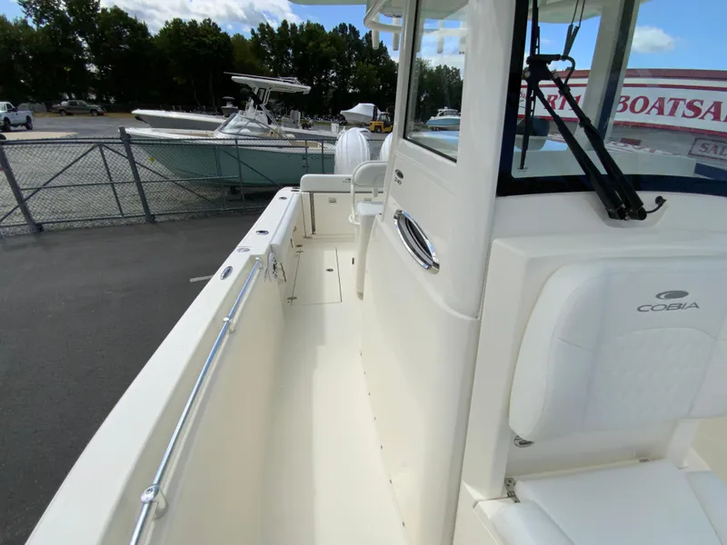 Slide: The Image of 2025 Cobia 240 Center Console boat, white interior, docked at marina. - 29