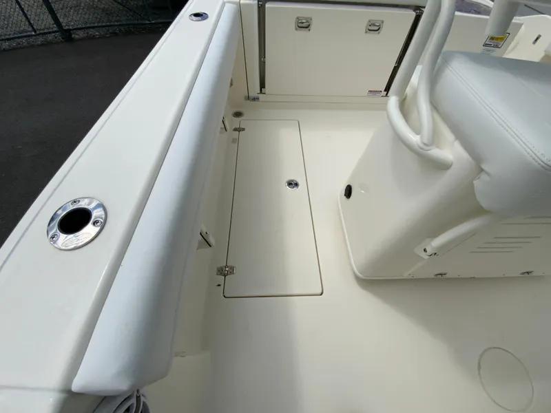 Slide: The Image of 2025 Cobia 240 Center Console boat interior, featuring seating and storage compartments. - 30