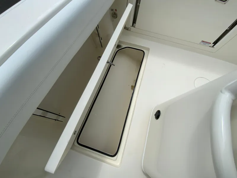 Slide: The Image of 2025 Cobia 240 Center Console boat storage compartment, open and empty. - 31
