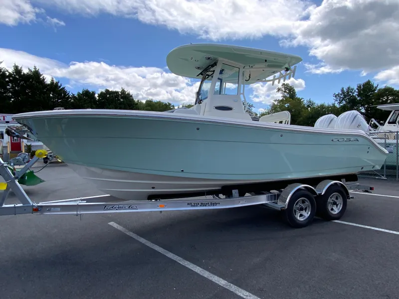 Slide: The Image of 2025 Cobia 240 Center Console boat on trailer under cloudy sky. - 5