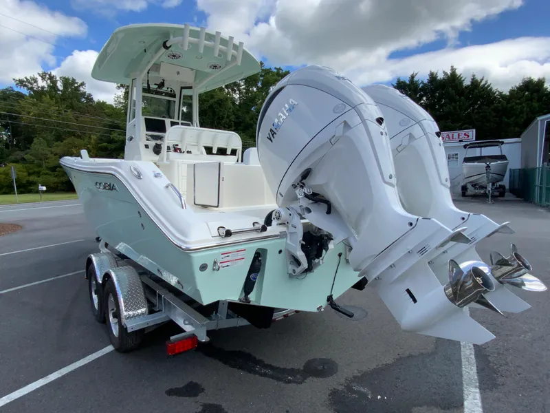Slide: The Image of 2025 Cobia 240 Center Console boat with dual Yamaha engines on a trailer. - 7