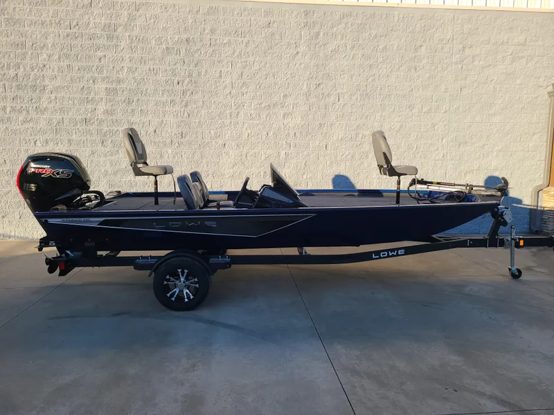Slide: The Image of 2024 Lowe ST195B fishing boat on trailer, side view, parked outdoors. - 10