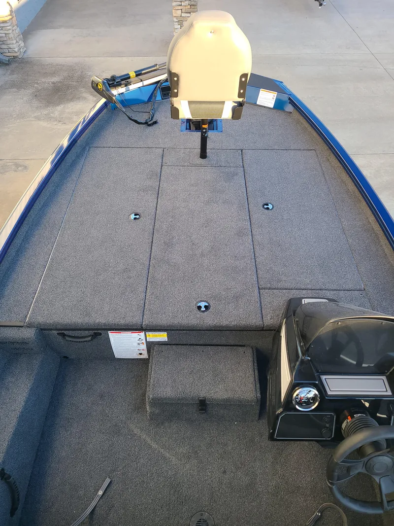 Slide: The Image of 2024 Lowe ST195B boat interior with carpeted deck and steering console. - 4