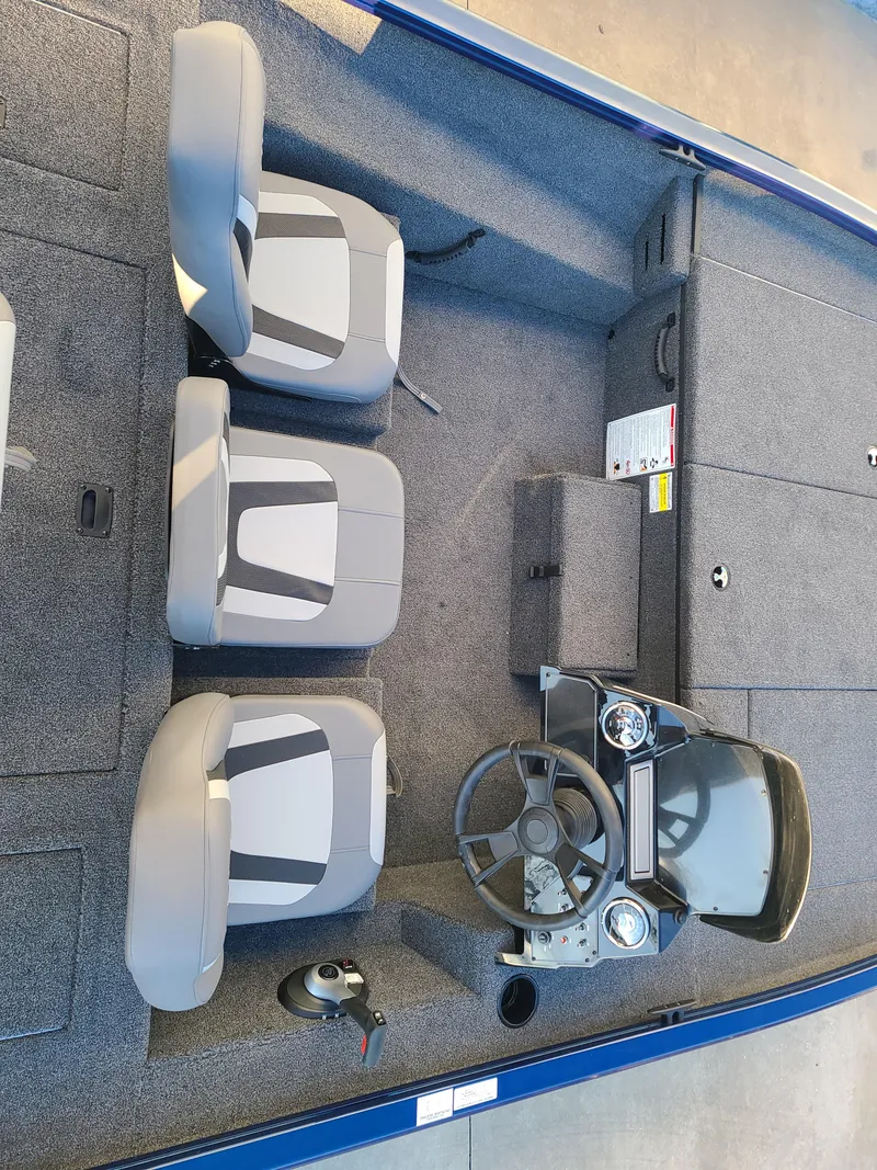 Slide: The Image of 2024 Lowe ST195B boat interior with steering console and seating arrangement. - 5