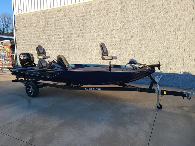 Slide: The Image of 2024 Lowe ST195B fishing boat on trailer, parked outdoors. - 9
