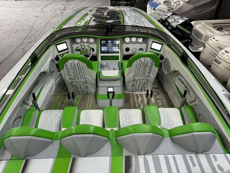 Slide: The Image of Luxurious 2021 Skater 50 speedboat interior with green and gray seating and advanced dashboard controls. - 10