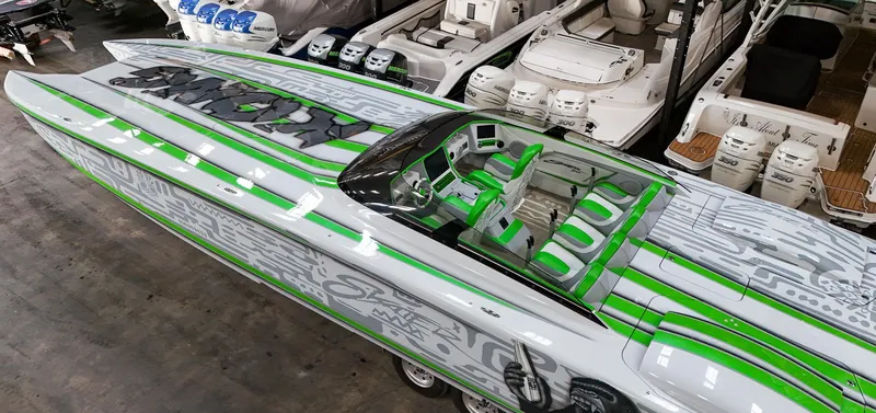 Slide: The Image of Skater 50 boat, 2021 model, with green and gray design, docked among other boats. - 14