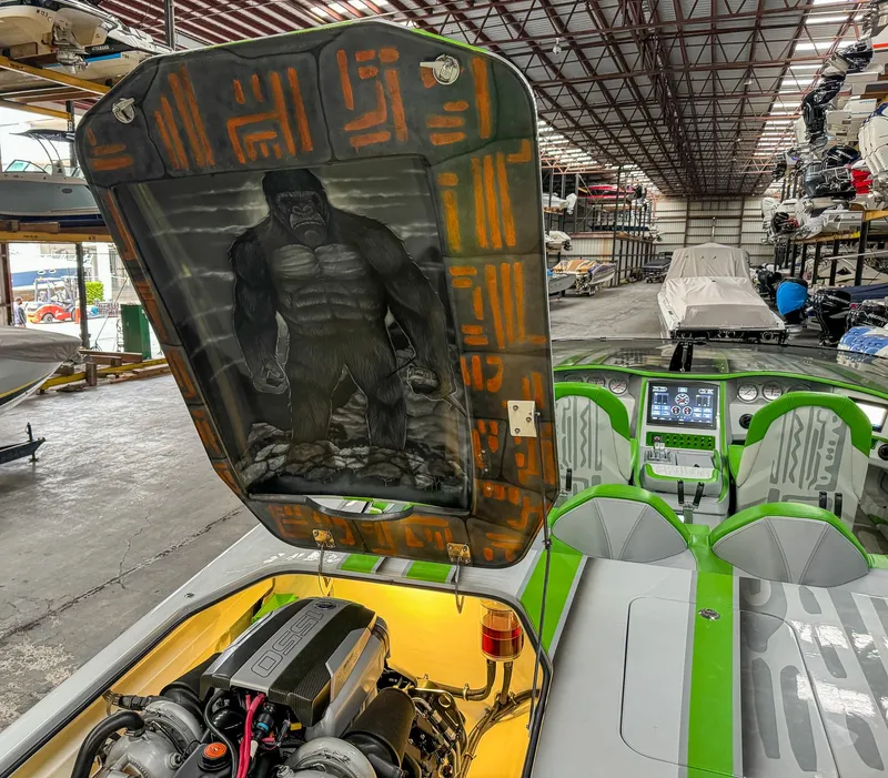 Slide: The Image of Skater 50 boat with custom gorilla artwork under the engine hatch, in a storage facility. - 18