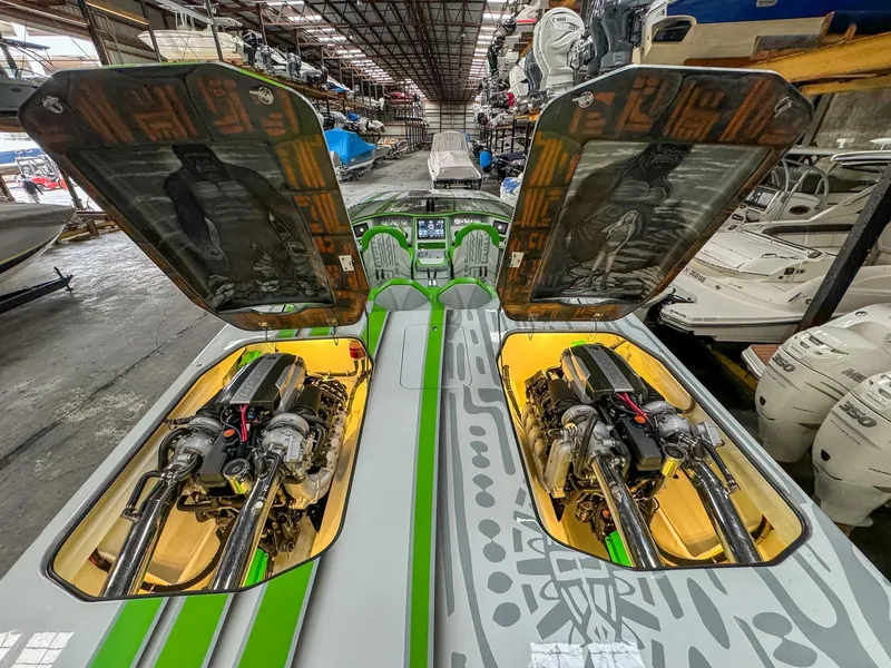 Slide: The Image of 2021 Skater 50 boat engines in a warehouse, hatches open, showcasing powerful machinery. - 25
