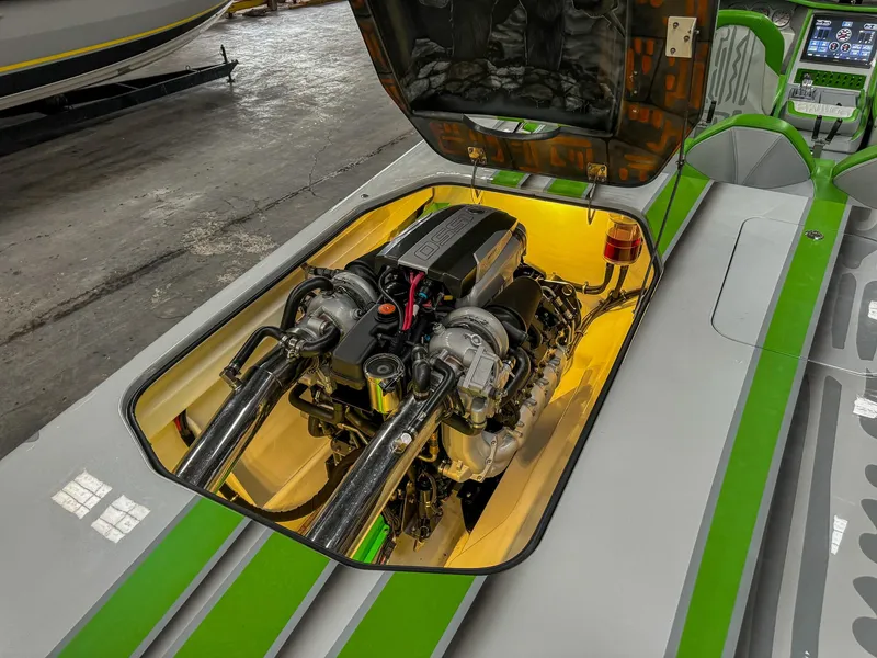 Slide: The Image of 2021 Skater 50 boat engine compartment with vibrant green accents. - 27