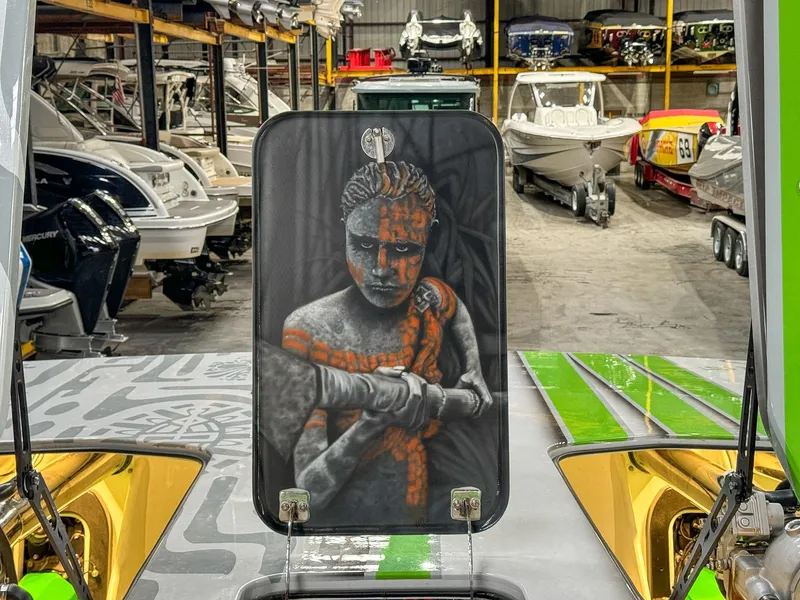 Slide: The Image of Custom Skater 50 boat with artistic design in a boat storage facility, 2021 model. - 29