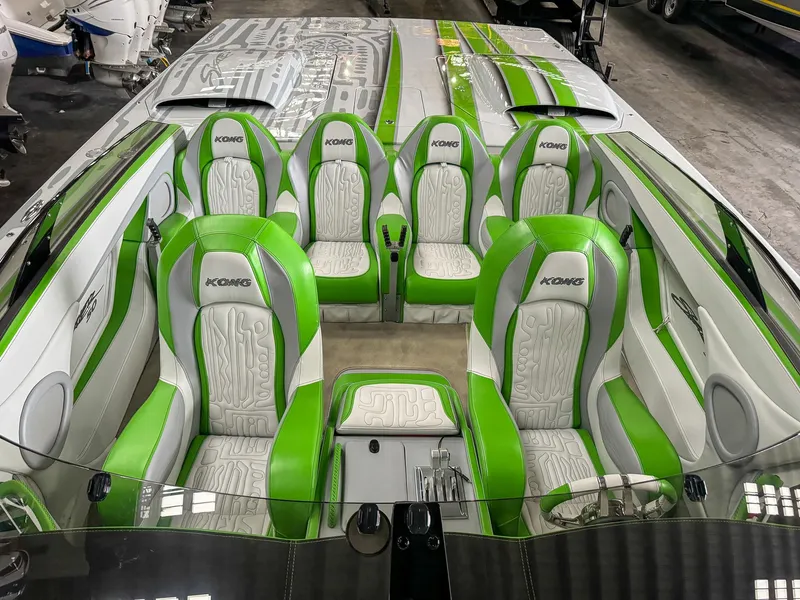 Slide: The Image of 2021 Skater 50 boat interior with green and white seats, sleek design. - 3