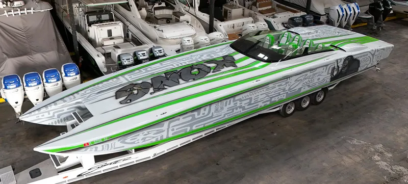 Slide: The Image of High-performance Skater 50 speedboat, 2021 model, with sleek green and gray design in a marina. - 30