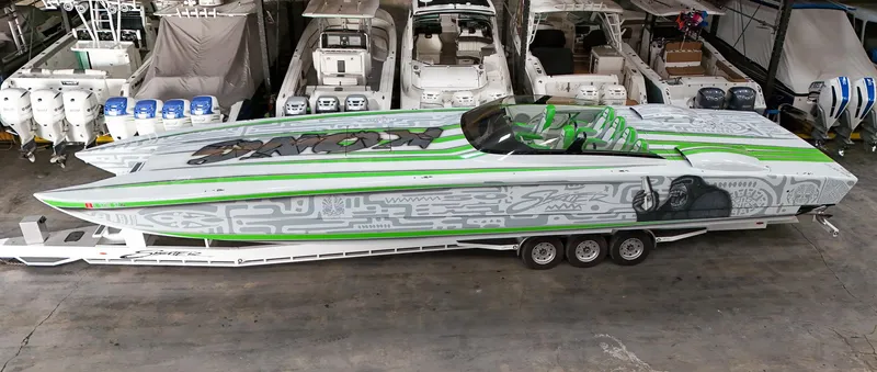 Slide: The Image of High-performance Skater 50 boat, 2021 model, with vibrant green and gray design in a storage facility. - 31