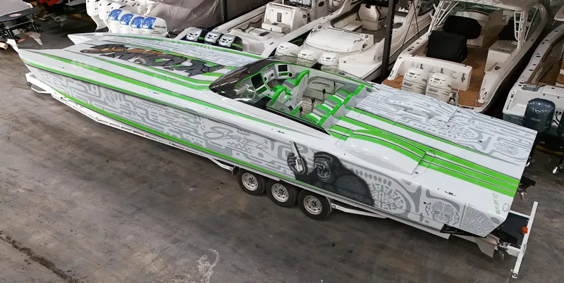 Slide: The Image of 2021 Skater 50 speedboat with green and gray design in a showroom. - 32