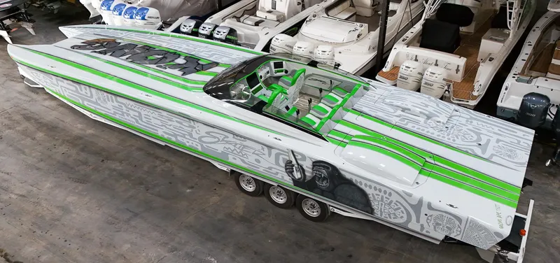 Slide: The Image of 2021 Skater 50 boat with green and gray design in a showroom. - 33