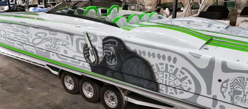 Slide: The Image of Custom Skater 50 speedboat with gorilla artwork, green accents, and sleek design, 2021 model. - 35