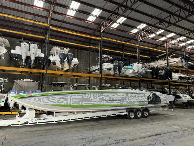 Slide: The Image of Skater 50 boat in storage facility, 2021 model, with vibrant green and gray design. - 36