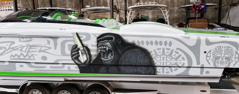 Slide: The Image of Custom Skater 50 boat with gorilla mural, 2021 model, in a showroom. - 37