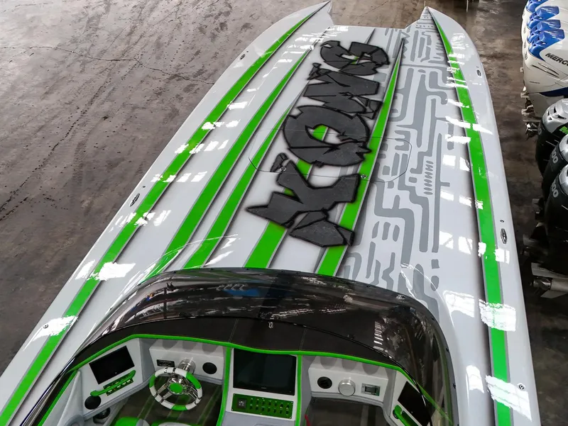 Slide: The Image of Skater 50 boat, 2021 model, with vibrant green and gray design, featuring "KONG" graphics. - 38