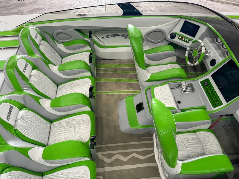Slide: The Image of Luxurious Skater 50 boat interior, 2021 model, featuring green and white seating and modern dashboard. - 4