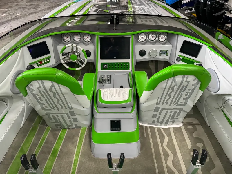 Slide: The Image of 2021 Skater 50 boat interior with green accents, modern dashboard, and dual seating. - 48