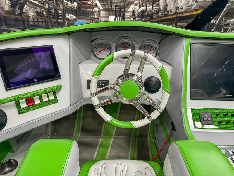 Slide: The Image of Green and white Skater 50 boat dashboard, featuring modern controls and steering wheel, 2021 model. - 7