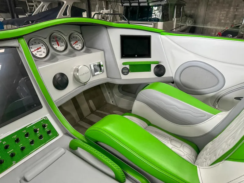 Slide: The Image of Luxurious Skater 50 boat interior, 2021 model, featuring green and white seating with modern dashboard. - 8