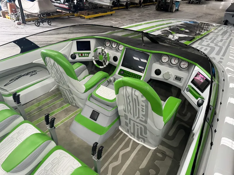 Slide: The Image of 2021 Skater 50 boat interior with green and gray seating, modern dashboard, and steering wheel. - 9