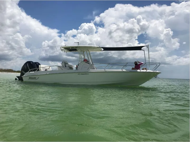 The Image of 2016 Boston Whaler 270 Dauntless boat on calm green water under cloudy sky. - 12