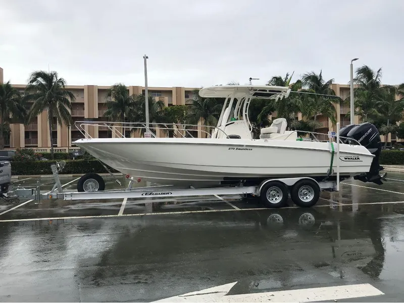 Slide: The Image of 2016 Boston Whaler 270 Dauntless boat on trailer in parking lot. - 13