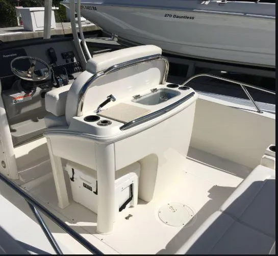 Slide: The Image of 2016 Boston Whaler 270 Dauntless boat interior with helm and seating area. - 16