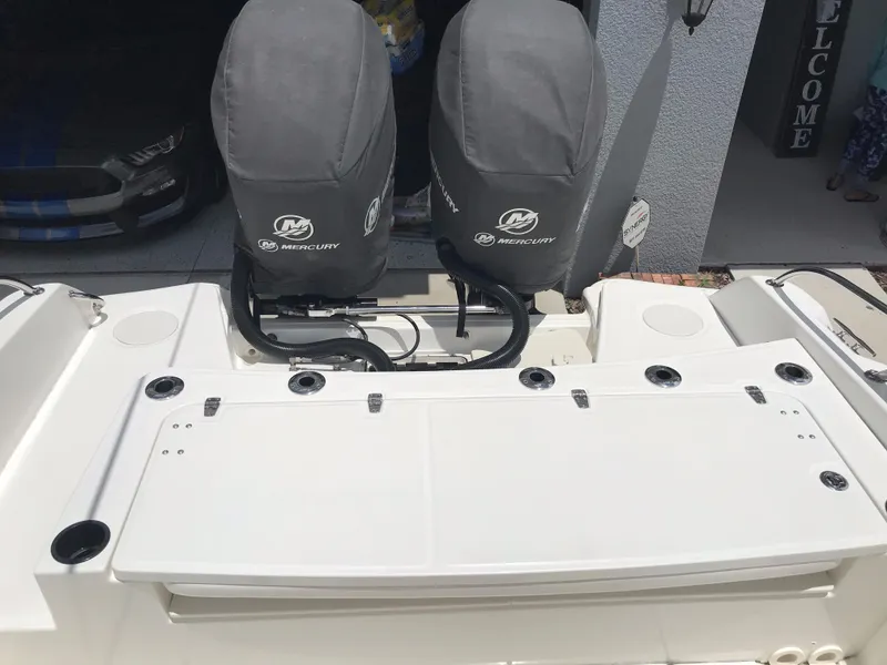 Slide: The Image of 2016 Boston Whaler 270 Dauntless boat with dual Mercury engines, covered and docked. - 19