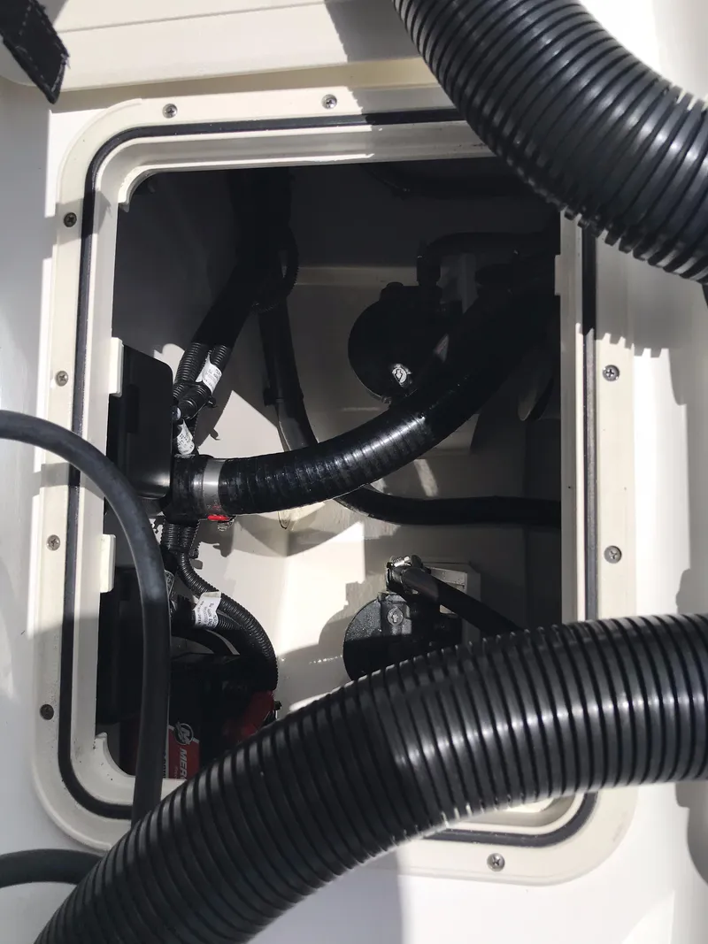 Slide: The Image of 2016 Boston Whaler 270 Dauntless engine compartment with hoses and wiring. - 20