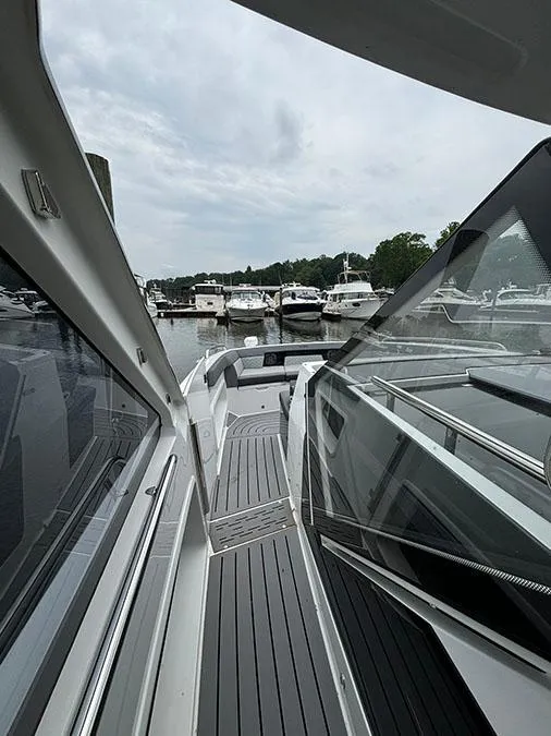 Slide: The Image of 2024 Galeon 325 GTO yacht docked at a marina, showcasing sleek design and modern features. - 11