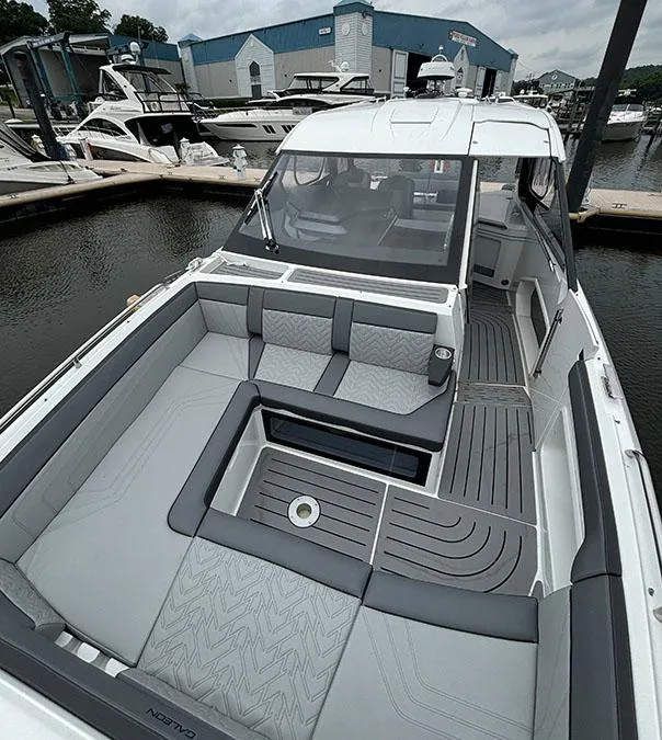 Slide: The Image of 2024 Galeon 325 GTO luxury boat with spacious seating at a marina. - 14