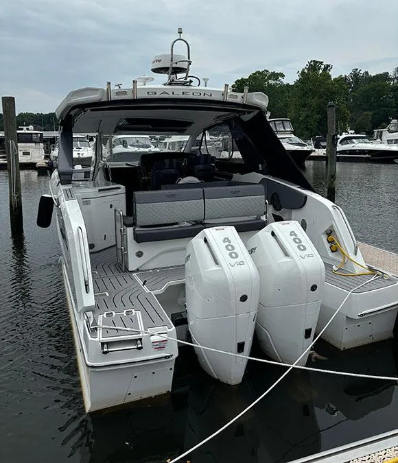 Slide: The Image of 2024 Galeon 325 GTO luxury yacht docked at marina with twin outboard engines. - 16