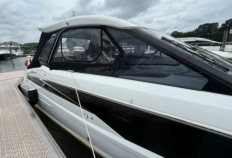 Slide: The Image of 2024 Galeon 325 GTO docked at a marina on a cloudy day. - 2