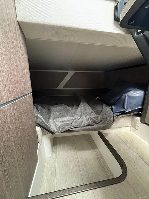 Slide: The Image of 2024 Galeon 325 GTO cabin interior with bed and storage space. - 25