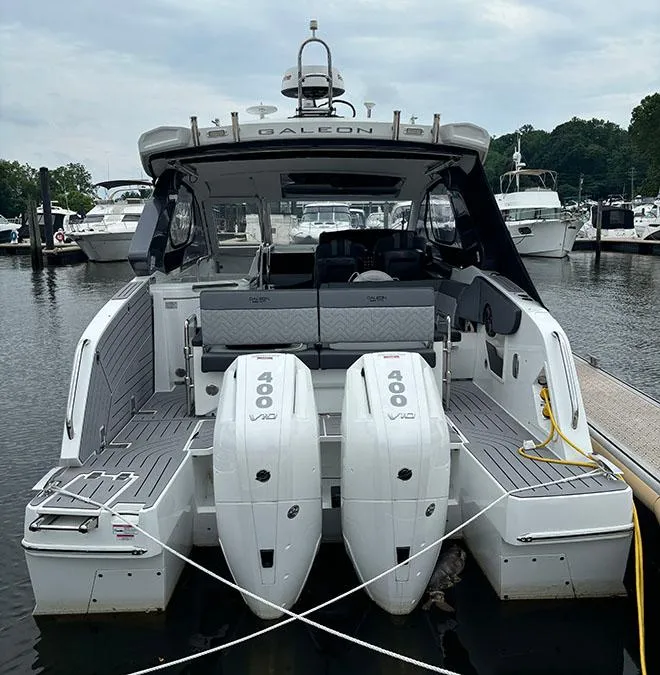 Slide: The Image of 2024 Galeon 325 GTO luxury yacht with twin 400 V8 engines docked at a marina. - 3