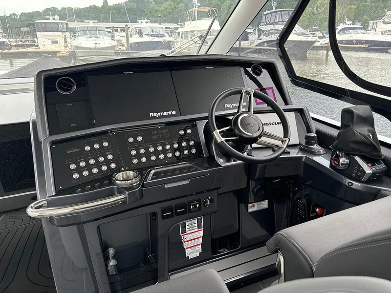 Slide: The Image of 2024 Galeon 325 GTO helm with Raymarine electronics and Mercury steering wheel. - 5