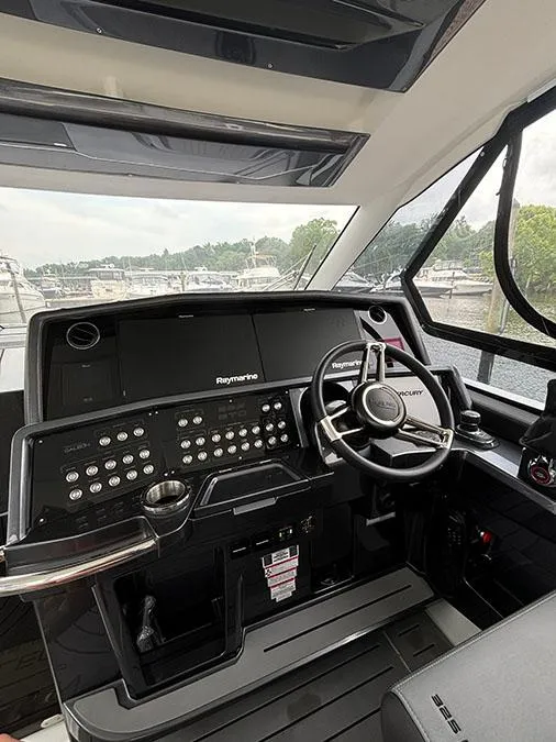 Slide: The Image of 2024 Galeon 325 GTO helm station with advanced navigation controls and steering wheel. - 6