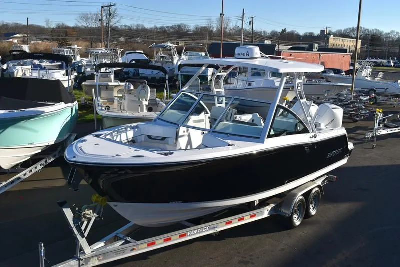 The Image of 2024 Blackfin 252DC boat on trailer in marina setting. - 1