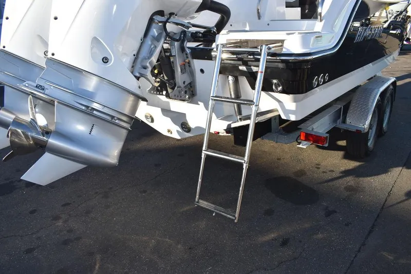 Slide: The Image of 2024 Blackfin 252DC boat on trailer with ladder and outboard motor. - 12